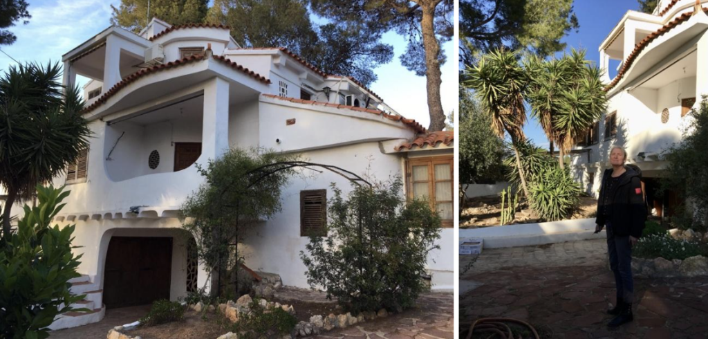 Een tevreden klant poseert trots voor haar nieuwe woning in Valencia, omringd door prachtige mediterrane natuur. Dankzij de begeleiding van Marja werd haar droomhuis werkelijkheid.